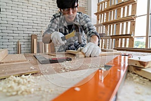 Carpenter working on wood craft at workshop