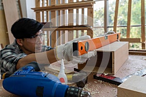 Carpenter working on wood craft at workshop