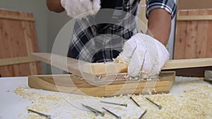 Carpenter working on wood craft at workshop