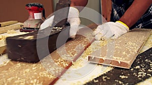 Carpenter working on wood craft at workshop