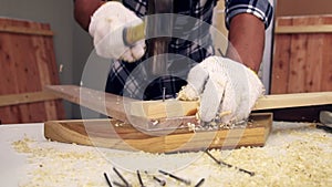 Carpenter working on wood craft at workshop