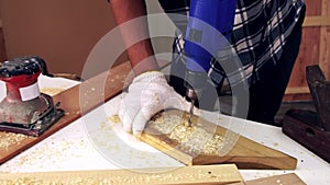 Carpenter working on wood craft at workshop