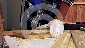 Carpenter working on wood craft at workshop