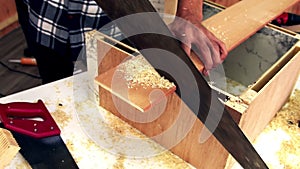 Carpenter working on wood craft at workshop