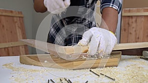 Carpenter working on wood craft at workshop