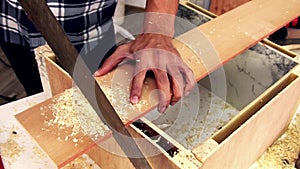 Carpenter working on wood craft at workshop