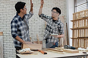 Carpenter working on wood craft at workshop