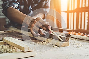 Carpenter working on wood craft at workshop