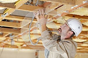 carpenter working on wood structure on residential construction