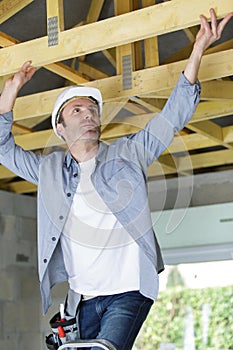 carpenter working on wood structure on residential construction