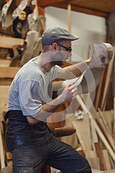 Carpenter working on wooden forcola for venetian gondola