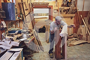 Carpenter working on wooden forcola for venetian gondola