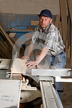 Carpenter working on woodworking machines