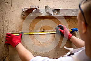 Carpenter working on woodworking machines in carpentry shop