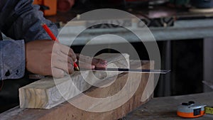 Carpenter working on woodworking machines in carpentry shop