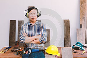 Carpenter working on woodworking machines in carpentry shop