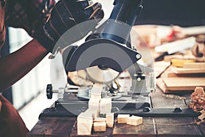 Carpenter working on woodworking machines in carpentry shop, wooden product