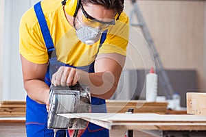 The carpenter working in the workshop