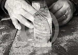 Carpenter workplace- Carpenter workplace. Man using saw to cut wood.