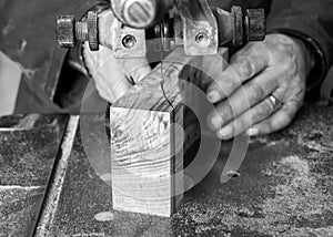 Carpenter workplace- Carpenter workplace. Man using saw to cut wood.