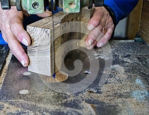 Carpenter workplace- Carpenter workplace. Man using saw to cut wood