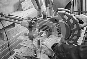 Carpenter workplace- Man using circular saw to cut wood.