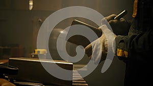 Carpenter works as a file for metal. Worker grinding iron. A man works with a metal iron pipe file in a garage workshop. Close-up