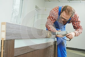 Carpenter works with drill