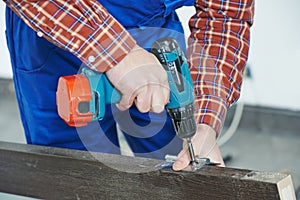 Carpenter works with drill