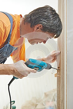 Carpenter works with drill