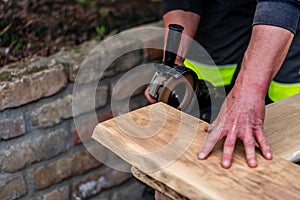 A carpenter works in a garden