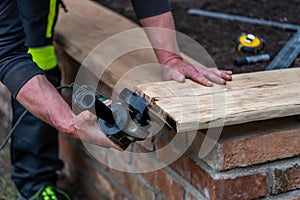 A carpenter works in a garden