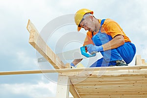 Carpenter works with hand saw