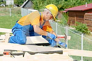 Carpenter works on roof