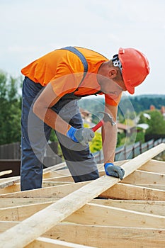Carpenter works on roof