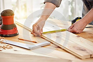 Carpenter works with wood in the workshop. A woman works in a carpentry workshop