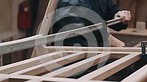 Carpenter in the workshop working on the creation of handmade wooden furniture. Profession, joinery, Craftsmanship