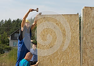 Carpenters erecting wall panels on a new build