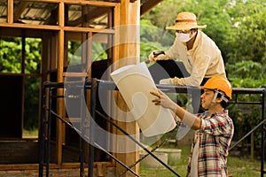 Carpenters are planning to build a home photo