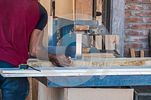 Carpenters using circular saw in workshop