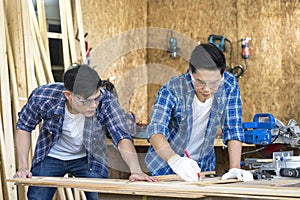 Carpenters working in teamwork. Wood processing apprenticeship at carpentry shop