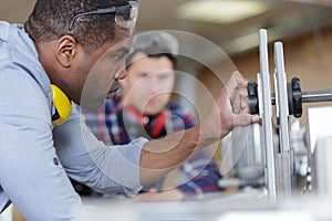 carpentry apprentice learning to use circular saw