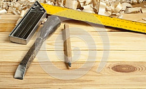 Carpentry concept.Joiner carpenter workplace. Construction tools on wooden table with shavings. Copy space for text.