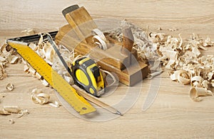 Carpentry concept.Joiner carpenter workplace. Construction tools on wooden table with shavings. Copy space for text.