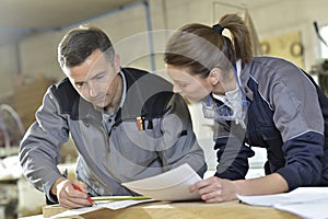Carpentry instructor teaching trainee