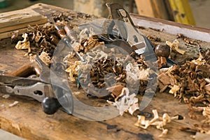 Carpentry tools. A carpenter`s work table, full of tools and wood waste.