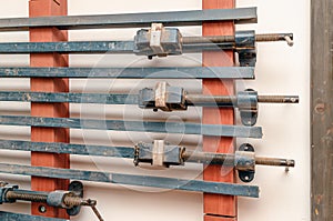 Carpentry tools hang on the wall of the production workshop. Wood processing
