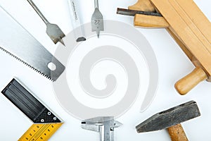 Carpentry tools: planer, chisel, wood saw, square carpenter, hammer, wood drills on a white background top view