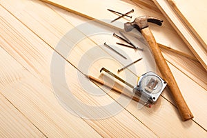 Carpentry tools on wooden background