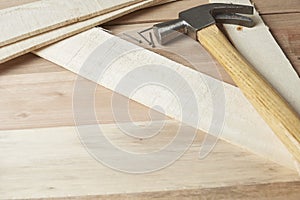 Carpentry work table, wooden surface with some wooden strips, nails and a hammer